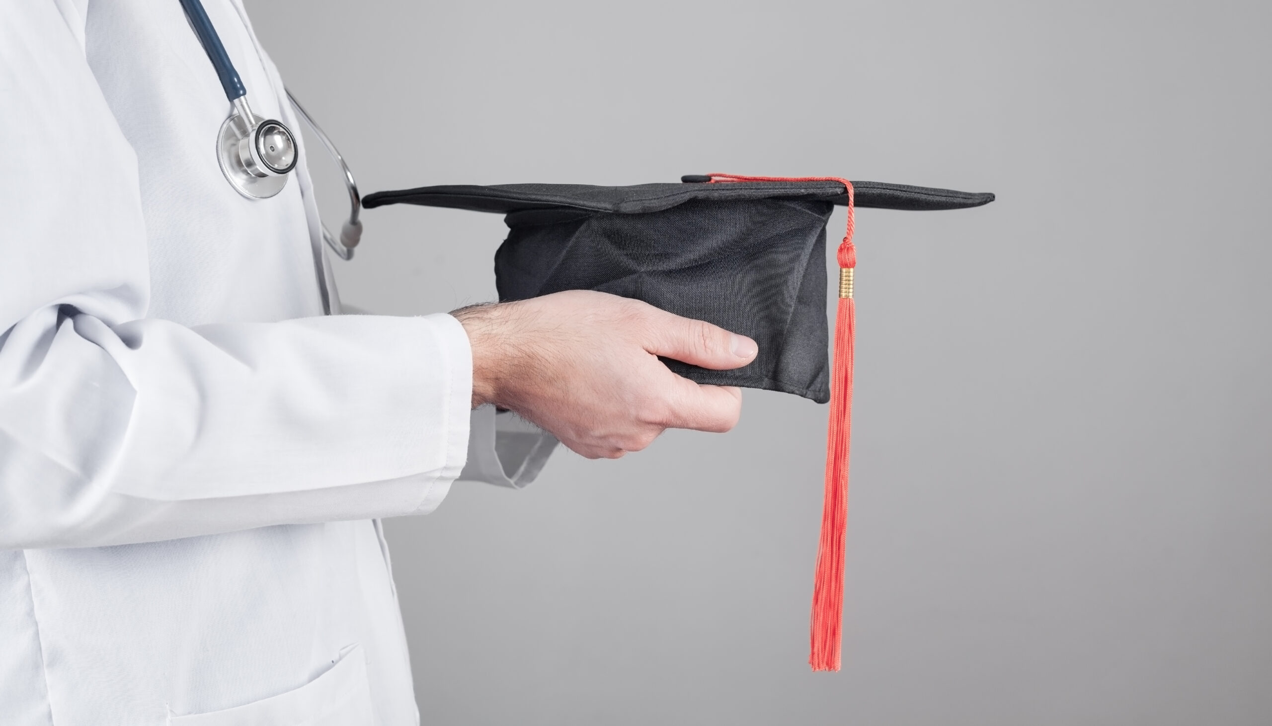 Caucasian,Doctor,Holding,Graduation,Hat.,Medical,Education